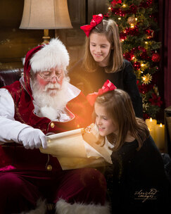 Boise Santa looking at Naughty and Nice List with Girls