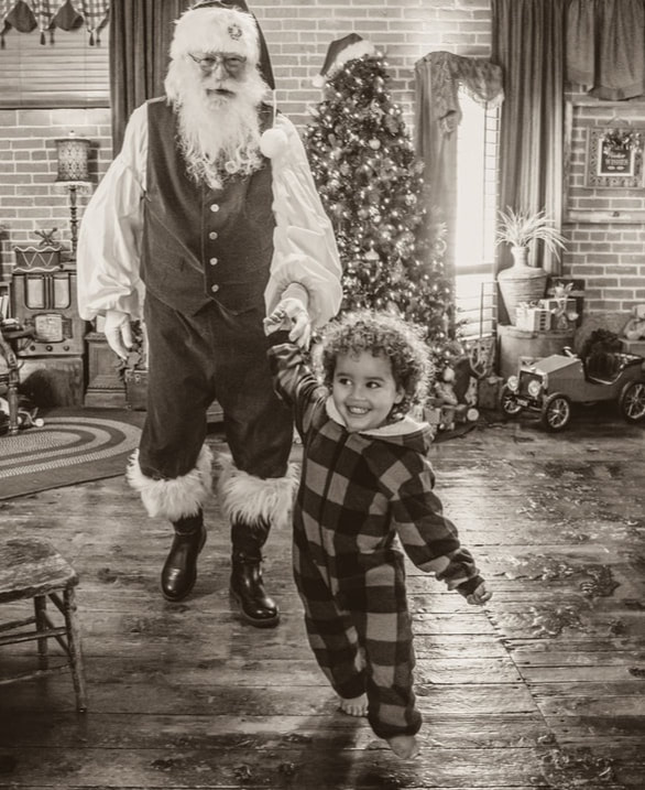 Boise Santa looking at Naughty and Nice List with Girls